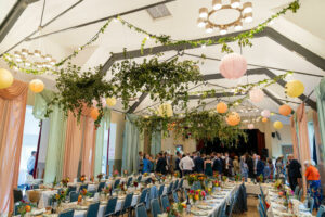 Moor Pool Hall decorated with drapes, hanging foliage and paper lanterns